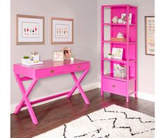 a pink desk and bookcase in a room with white rugs on the floor