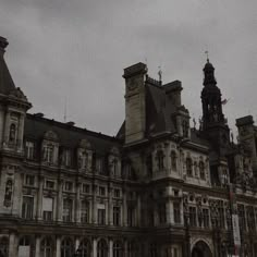 an old building with two clocks on the top of it's towers and steeples