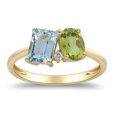 This alluring toi et moi ring features one emerald cut blue topaz, one oval peridot and one brilliant cut diamond accent in a glistening 10K yellow gold setting. | Blue Topaz, Peridot and Diamond Toi et Moi Ring | 10K Yellow Gold | Size 7.5 | 2mm | Helzberg Diamonds Dual Birthstone Engagement Rings, Three Stone Rings Gemstone, Birthstone Engagement Rings, Peridot Engagement Rings, Family Ring, Multi Gemstone Ring, Helzberg Diamonds, Peridot Stone, Big Rings