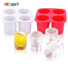 three ice trays, one filled with yellow liquid and two empty plastic cup holders