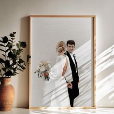 a framed photograph of a bride and groom