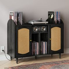 an entertainment center with record players and speakers