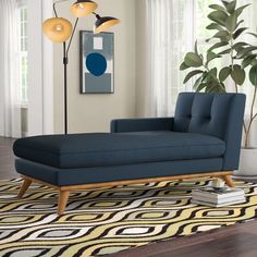 a living room scene with focus on the chaise - long sofa and floor lamp