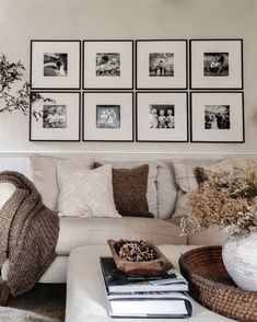 a living room filled with lots of furniture and pictures on the wall above it's coffee table