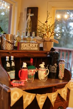 there is a christmas display on the shelf in the living room with cups and mugs