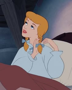 an animated image of a woman laying in bed with her hand on her chin and looking off to the side