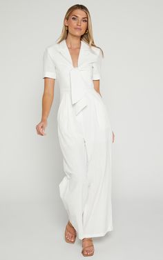 Get ready to turn heads in the Naples Wrap Front Jumpsuit In White! This wide leg jumpsuit is perfect for those casual summer days or dress it up with some heels for a night out. Made from 100% cotton, this jumpsuit is lightweight and breathable, keeping you cool and comfortable all day long. With its flattering wrap front detail and short sleeves, this jumpsuit will accentuate your figure in all the right places. So go ahead, embrace your playful side and add this flirty white jumpsuit to your White Jumpsuit Outfit, Jumpsuit Outfit Casual, Red Sequin Dress, Tiered Dresses, Basic Black Dress, Neon Outfits, Bachelorette Dress, Short Playsuit, Jumpsuit Outfit