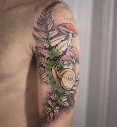 a man's arm with a snail and leaves tattoo design on the left shoulder