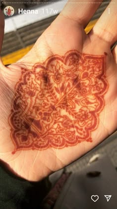 a person's hand with an intricate design on it