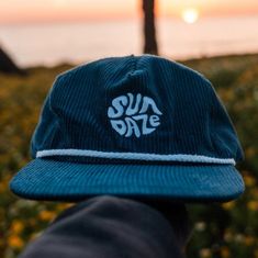 The Dark Blue Corduroy SunDaze Circle 5-panel hat effortlessly captures the essence of the 80's surf era, combining classic design elements with a modern twist. Crafted from high-quality, deep blue corduroy fabric, this cap showcases a distinctive circular emblem on its front panel, paying homage to the iconic sun-soaked days of the 1980s surfing culture. The dark blue hue of the corduroy resembles the vastness of the oceans waves coming in from the horizon, while simultaneously giving a nod to the nostalgic vibes of the era it draws inspiration from. The 5-panel construction of the cap ensures a comfortable and snug fit, suitable for various head shapes and sizes. The design incorporates the signature snap-back feature, allowing for easy adjustment to achieve the perfect fit. This functio Surf Hats, Corduroy Hat, 5 Panel Hat, Blue Corduroy, Vintage Surf, Panel Hat, The 80's, Cute Hats, Cool Hats