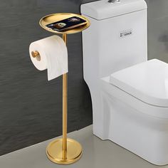 there is a toilet with a gold stand next to it