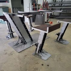 two metal chairs sitting on top of each other in a room with lots of machines