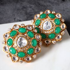 Type: Studs Earring Closure Type: Push Back with German Clip Total Weight: 18 Grams (combined) Approx. Dimensions: 33 mm x 33 mm (end to end) Finish: Matte Gold Elements include: Hand cut glass work (Polki/Kundan) AAAAA Cubic Zirconia Natural Stones - treated - dyed or heated Colour Palette: Green Please note: All the pieces in store are BRASS AND COPPER based No lead or nickel or zinc. Care trips: Store in airtight bags (provided) Like all jewellery it should be the last thing you put on and the first thing you take off Handle gently yet firm hands Colour Palette Green, Palette Green, Snowflake Ring, Glass Work, Shell Ring, Floral Earrings, Matte Gold, Gold Bangles, Stone Earrings