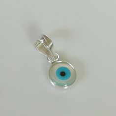 ▪︎ Tiny sterling silver evil eye charm/ pendant. ▪︎ Size: 6 x 9 mm Jump ring: 5 mm ▪︎ This is a multi functional charm and can be used with neck chains, ear hoops, bracelets, anklets, key chains etc. ▪︎ This pendant is handmade with hypoallergenic sterling silver, and is nickel free. Comes with a 925 mark for authenticity. ▪︎ Please note: Price listed is for ONE charm. This pendant comes WITHOUT the chain, however, you can add a snake neck chain, bracelet chain or hoop in the required size while Silver Symbolic Good Luck Charms, Silver Good Luck Symbolic Charms, Sterling Silver Good Luck Pendant Charms, Good Luck Sterling Silver Pendant Charms, Handmade Round Pendant Charms For Gifts, Sterling Silver Dangle Evil Eye Jewelry, Sterling Silver Evil Eye Teardrop Jewelry, White Good Luck Charm Necklaces, White Round Pendant Necklace For Good Luck