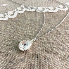 "Heatherly Designs simple pendant necklace made using a genuine teardrop Swarovski® crystal in colorless 'Crystal'. Necklace chain, setting and findings are plated brass. ●Nickel free ●Length (adjustable): 17\" - 19\" or 43.18 - 48.26cm ●Pendant Size: 14x10mm ●Swarovski® crystal color(s): Crystal ●Matching Earrings: http://etsy.me/1KcIUID ●Matching Bracelet: http://etsy.me/2a6MZi9 ●Arrives in our signature Heatherly gift box. Handmade with ❤ by Heather ● ● ● ● ● ● ● ● ● ● ● ● ● ● ● ● ● ● ● ● ● ● Crystal Teardrop Pendant Necklace Gift, White Crystal Teardrop Drop Necklace, Pear-shaped Crystal Drop Necklace Gift, Teardrop Crystal Drop Necklace For Anniversary, Crystal Teardrop Drop Necklace For Anniversary, Crystal Teardrop Pendant Necklace For Anniversary, Crystal Teardrop Necklace For Anniversary, Teardrop Crystal Necklace For Gift, Crystal Necklace With Teardrop Pendant For Gift