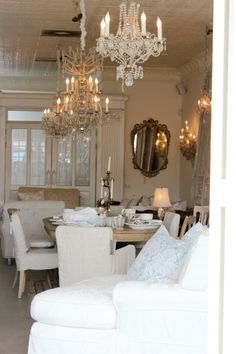 a living room filled with furniture and a chandelier