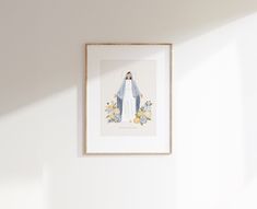 a framed photo hanging on the wall above a bed in a room with white walls