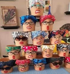 a group of mannequin heads with different types of head coverings on them