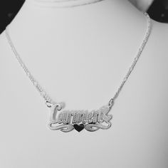 -Carmen Handmade Item. -Style: Brush Finish  -Material:  Solid 925 Sterling Silver. -Purity: Silver .925 - Link type: Figaro. -Clasp: Lobster claw. -Thickness Chains: 2.5mm. -Necklace length available: (16", 17", 18", 19", 20",21, 22"). (The name pendant is included in necklace length measurement. The necklace is laid  straight and measured end to end.) - Nameplate Letters: (Max 9 letters). Please First letter upper case and rest lower case. -Pendant Bar Measured: 1.50" Long x 0.50" Wide (38mm W Silver Hallmarked Name Necklace For Anniversary, Silver Sterling Engraved Name Necklace, Silver Engraved Name Necklace For Anniversary, Silver Sterling Name Necklace With Heart Pendant, Silver Sterling Heart Pendant Name Necklace, Silver Sterling Silver Heart Pendant Name Necklace, White Gold Sterling Silver Name Necklace With Hallmarks, Silver Name Necklace With Hallmarks For Mother's Day, Handmade Silver Nameplate Necklace