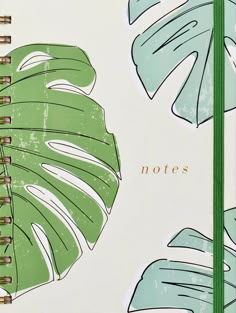 a notebook with palm leaves on it and the words notes written in gold foil is shown