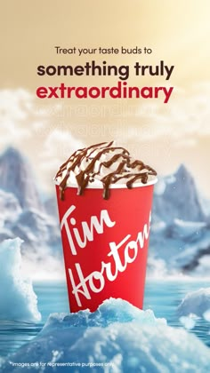 a red cup filled with chocolate sitting on top of an ice floet covered in snow