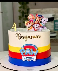 a birthday cake with paw patrol characters on it