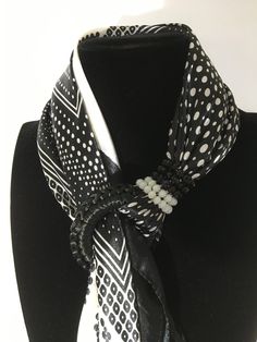 Black and white polka dot scarf blocked by a spiral of Swarovski beads and embellished with an embroidered ring and hard stone pendants. Materials 100% viscose scarf Spiral in Swarovski Fancy hard stones Embroidered crochet ring This women's scarf is perfect for you or for an original and unique gift, to surprise and please. It is advisable to wash it by hand in order to preserve the jewelry. Delivery Sending parcelsimo Delivery available from $120 purchase The scarves are sent in their pouch wi Embroidered Ring, Crochet Ring, Embroidered Crochet, Crochet Rings, Polka Dot Scarf, Swarovski Beads, White Polka Dot, Stone Pendants, Womens Scarves