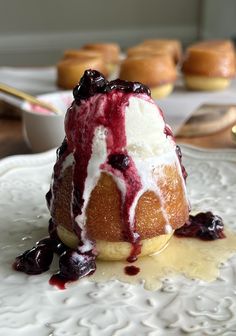 a dessert with blueberries and cream on a white plate