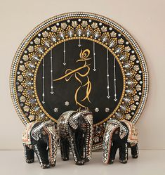 three elephants standing next to each other in front of a plate with an image on it