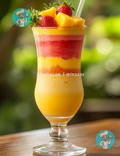 a glass filled with fruit on top of a wooden table