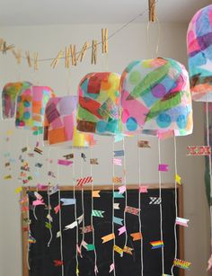 colorful paper lanterns hanging from strings in a room