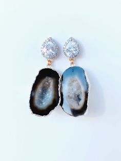 Meet, Gemma. One of our Signature styles. She features a Silver CZ post with a geode that is set in 24kt gold or silver. She can be customized and comes in other colors too. Please note, each geode is beautiful and unique. This is what makes each pair so special. Each stone is similar, but not exact. Please contact us directly to see images of the actual stone. CZ is also available in Rose Gold. Dimensions: 2” Elegant Jewelry With Gemstone Accents And Mineral Crystal, Elegant Gold Geodes For Gift, Elegant Gold Geodes With Natural Stones, Handmade Elegant Geodes For Gifts, Unique Handmade Gold Geodes, Gold Agate Jewelry For Wedding, Elegant Gold Geodes, Gold Geodes With Natural Stones As Gift, Unique Round Gemstone Geodes