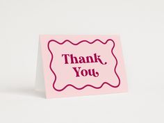 a pink thank card with the words thank you on it