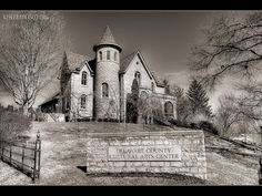 a black and white photo of the delaware county historical center in winter time with snow on the ground