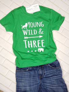 "When it comes to celebrating a 3rd birthday, a plain ol' shirt will never do! If your soon-to-be three year old is totally loveable but slightly wild? Does he LOOOOVE jungle animals? Then this \"Young Wild & THREE\" shirt will be a perfect match for your lil guy! ------------------------------------------------------------- 3rd Birthday shirt: All shirts are short-sleeve and fit true-to-size (boutique brand) - Long-sleeve shirts are available by special order. Please contact us before order Playful Green T-shirt For Birthday, Green Graphic Print T-shirt For First Birthday, Green T-shirt With Letter Print For First Birthday, Green Fun Birthday T-shirt, Birthday Letter Print Green Shirt, Green Short Sleeve Shirt For Birthday, First Birthday Green Top With Letter Print, Green Casual Top For First Birthday, Green Short Sleeve Top For First Birthday