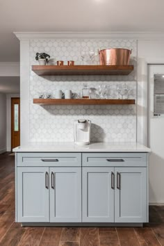 a kitchen with wooden shelves and white tile backsplash, wood flooring and open shelving