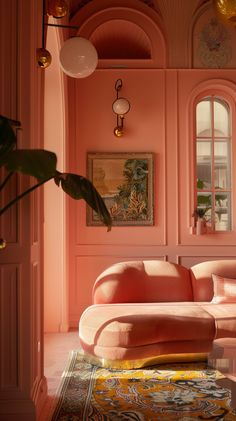 a living room with pink walls and furniture