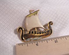 Rare Coro c1940's Gold Plated Sterling, Enameled Viking Ship Brooch Beautiful vintage brooch, hand enameled over gold plated sterling. The brooch is 2 inches long in good condition. There is very small scratch in the enamel on the bottom of the sail near the mast pole. Victorian Enamel Pin Collectible, Victorian Enamel Collectible Pin, Victorian Gold Enamel Pin, Victorian Style Gold Enamel Pin, Vintage Yellow Gold Enamel Pin For Collectors, Vintage Yellow Gold Enamel Pin Collectible, Collectible Gold Enamel Pins, Antique Enamel Pin For Formal Occasions, Vintage Yellow Gold Enamel Pin