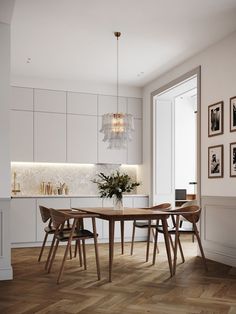 a dining room table with chairs and a chandelier hanging from it's ceiling