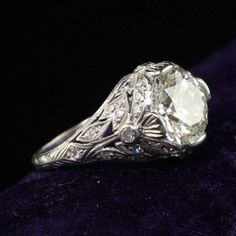 an antique style diamond ring with filigrees