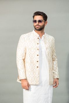 a man in a white suit and sunglasses