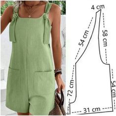 a woman is wearing a green dress and has her hand in her pocket while she's holding a purse