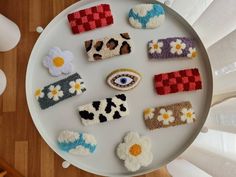 a white plate topped with lots of knitted items