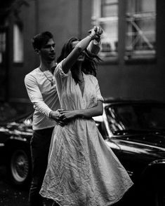 a man and woman dancing in the street