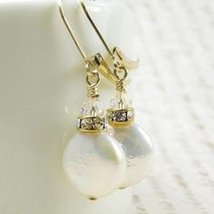 Beautiful pearl earrings are handmade with iridescent white coin pearls. Shaped liked little discs, these pearls are grown naturally from oysters seeded with a tiny disc shaped object. Perfect luster and polish on these coin pearl earrings. Accented with a Swarovski rhinestone crown and sparkly crystal. Dangles gracefully on 14k gold filled leverback earring closures.A great gift for a woman born in June since pearl is her birthstone.Earring Details:- Coin pearls are 12 mm- Pearl earrings are ju Round Pearl Pendant Earrings As Gift, Baroque Pearl Earrings In White, White Pearl Pendant Earrings For Celebration, Handmade Round Baroque Pearl Earrings, Baroque Pearl Earrings Gift, Baroque Pearl Earrings For Gift, Adjustable White Pearl Earrings For Anniversary, Pearl Drop Earrings For Anniversary, White Pearl Earrings As Gift