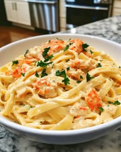 a white bowl filled with pasta covered in sauce