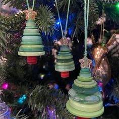 three ornaments hanging from a christmas tree