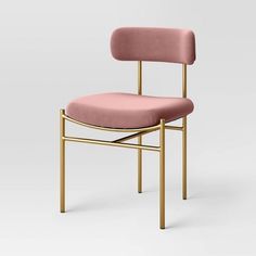 a pink upholstered chair with a gold frame and back support, viewed from the front