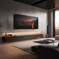 a living room with a large television on the wall next to a couch and coffee table