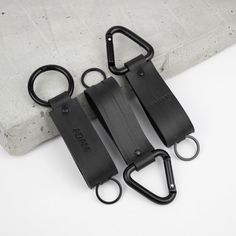 two pairs of black luggage straps sitting on top of a white surface next to each other